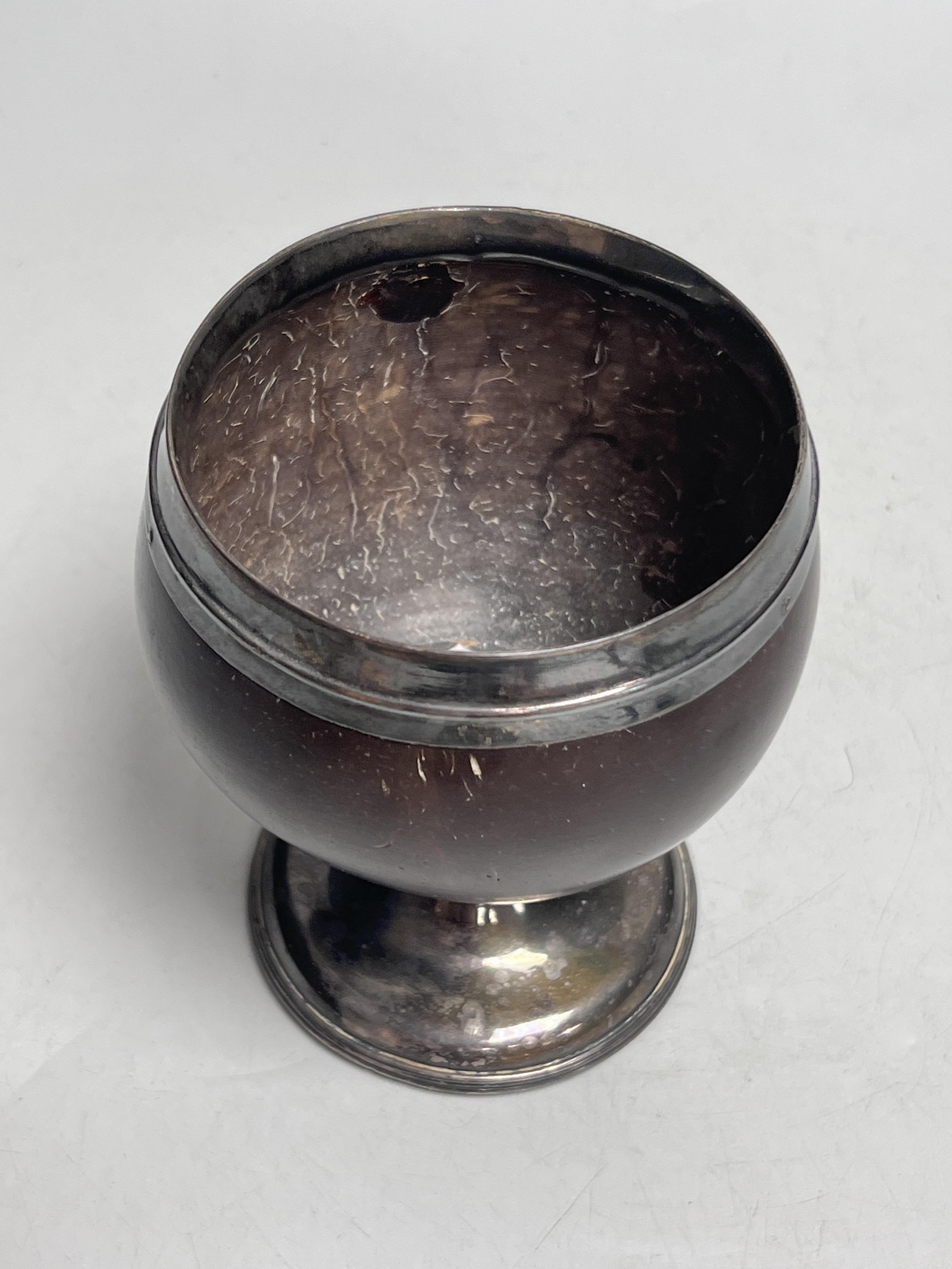 An early 19th century white metal mounted coconut cup, 13cm high
